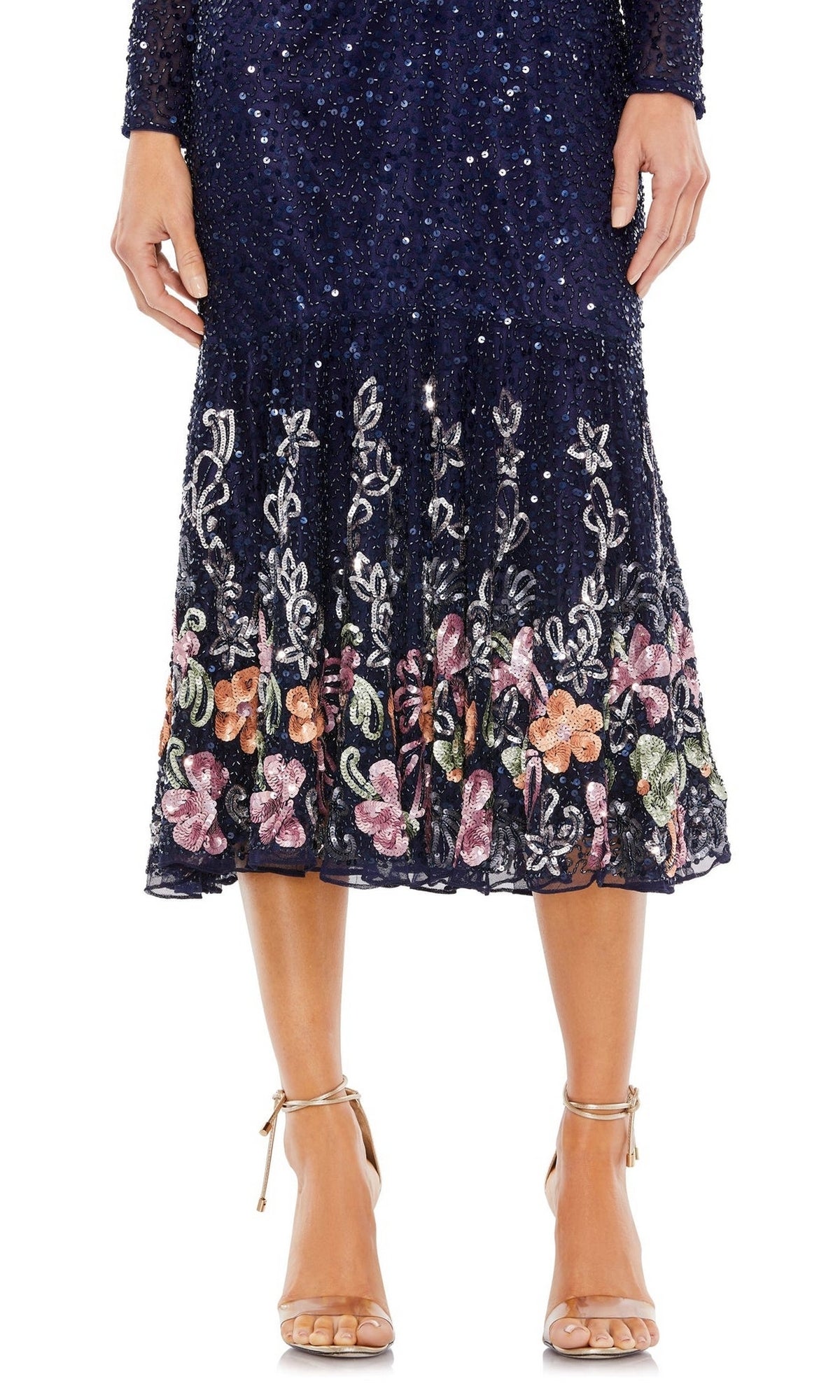 A person wearing the Mac Duggal 5589 Beaded Midi Wedding Guest Dress in navy blue with sequin and floral embroidery, paired with nude high-heeled sandals.